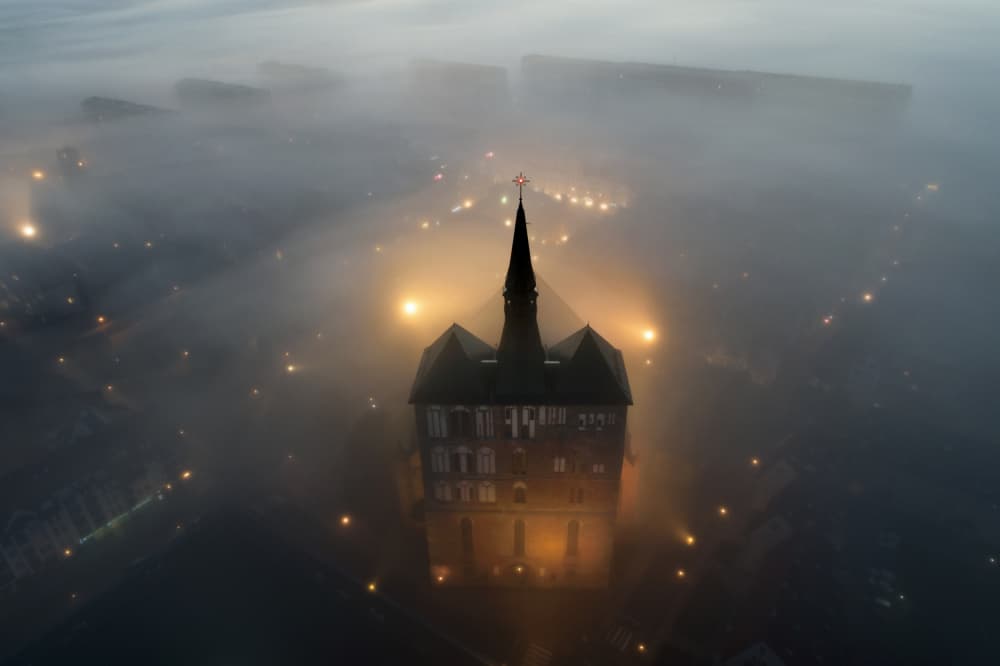 Glowing Spire in Fog by Łukasz Małkiewicz — canvas wall art