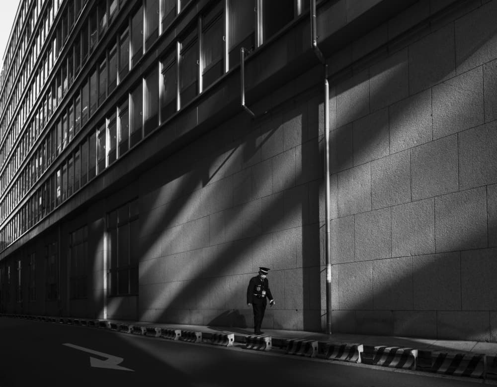 Guard Walks City Shadows by Yasuhiro Takachi — canvas wall art