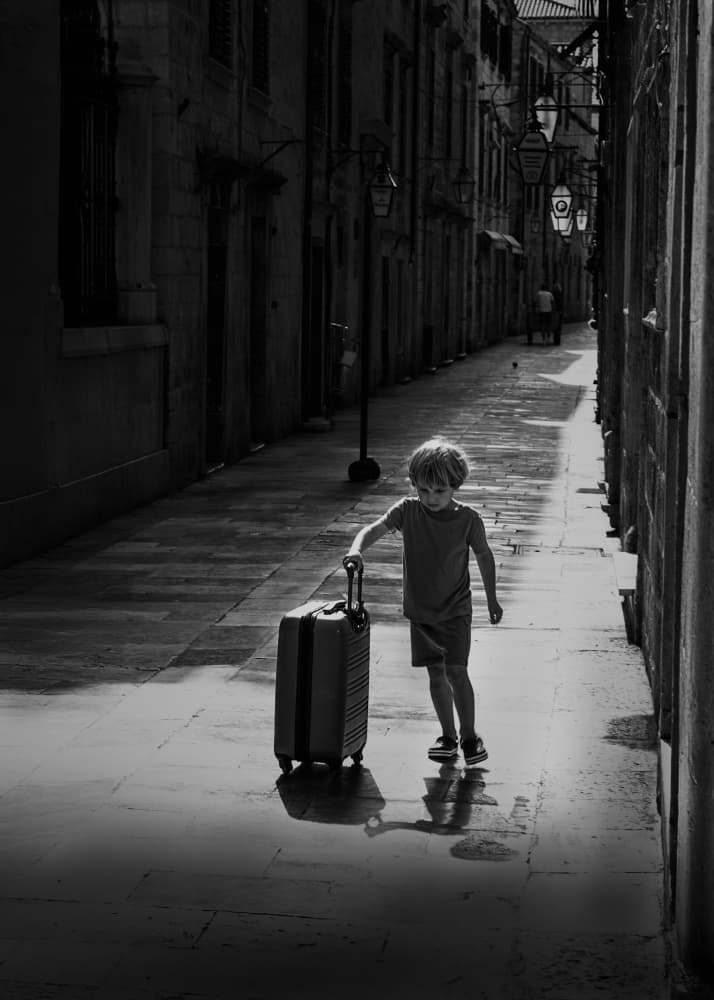 Little Boy with Suitcase by Dennis Zhang — canvas wall art