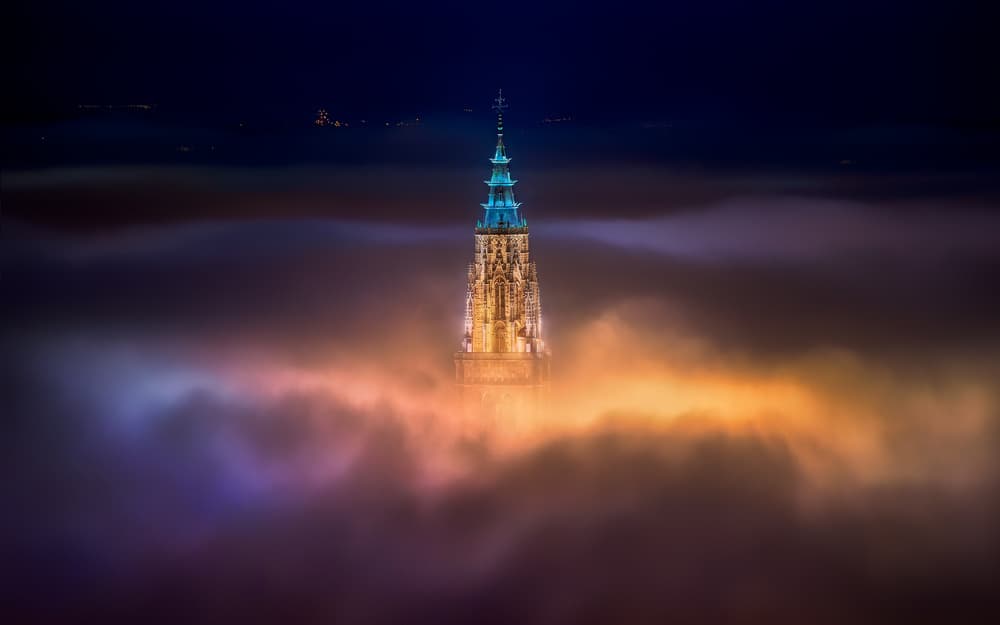 Glowing Tower Above Clouds by Jesús M. García — canvas wall art
