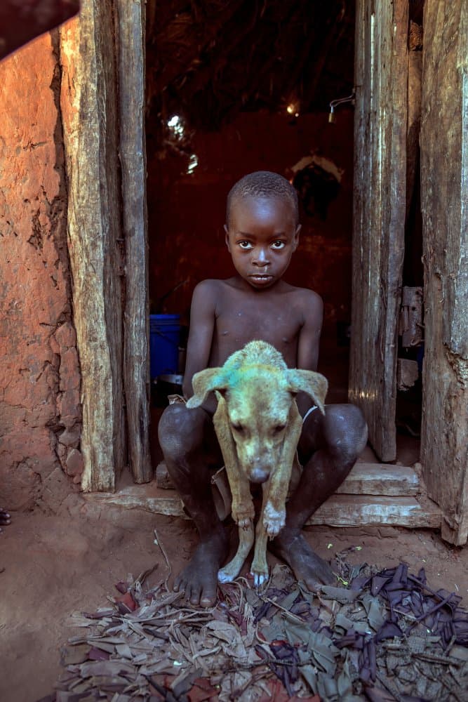 African Child And Puppy by Giuseppe DAmico — canvas wall art