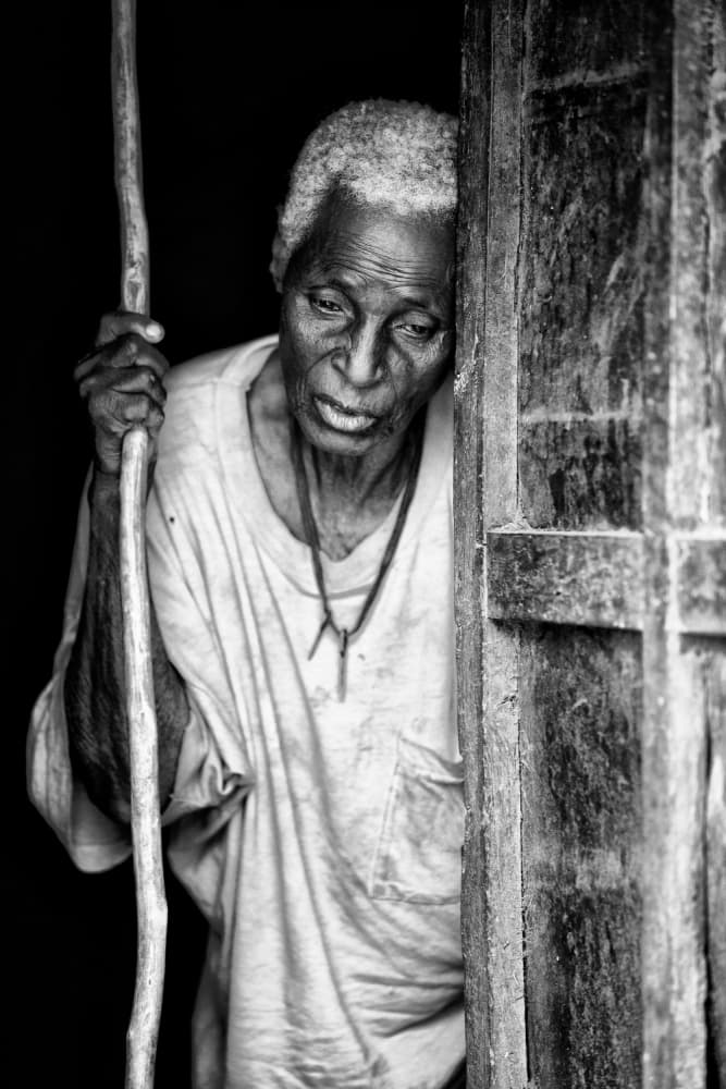 Elderly Woman Doorway by Goran Jovic — canvas wall art
