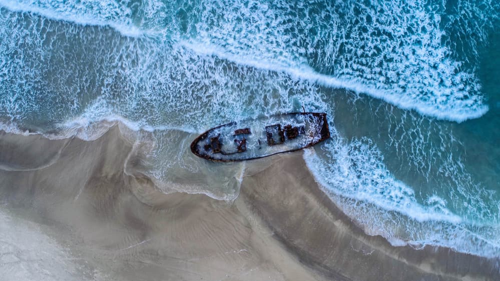 Shipwreck On Ocean Beach by Farid Kazamil — canvas wall art