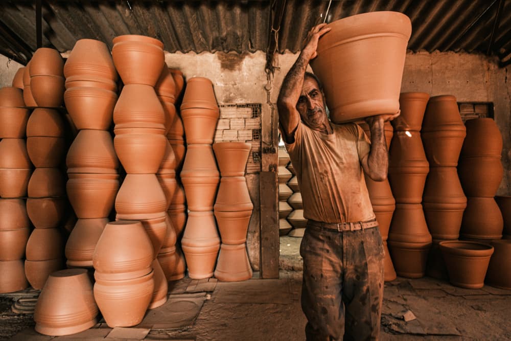 Artisan Carrying Clay Pot by Ali Ayer — canvas wall art