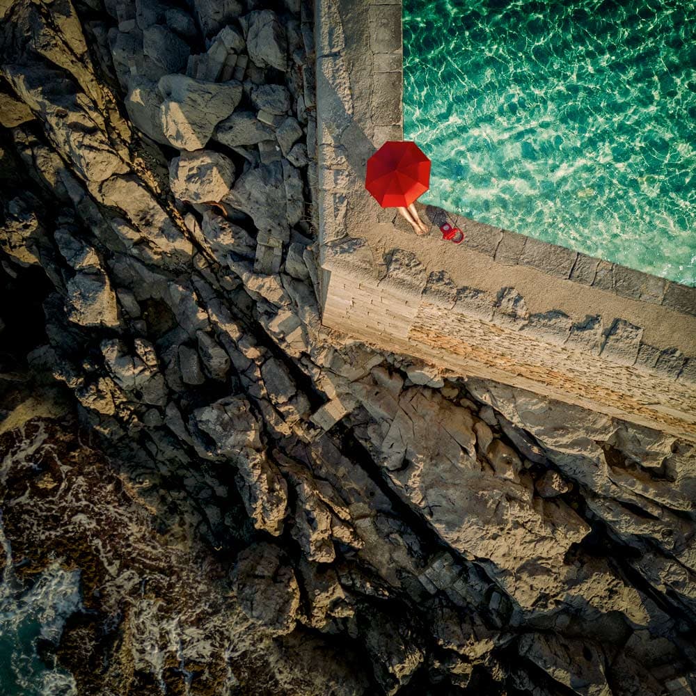 Clear Water Red Umbrella by ambra — canvas wall art