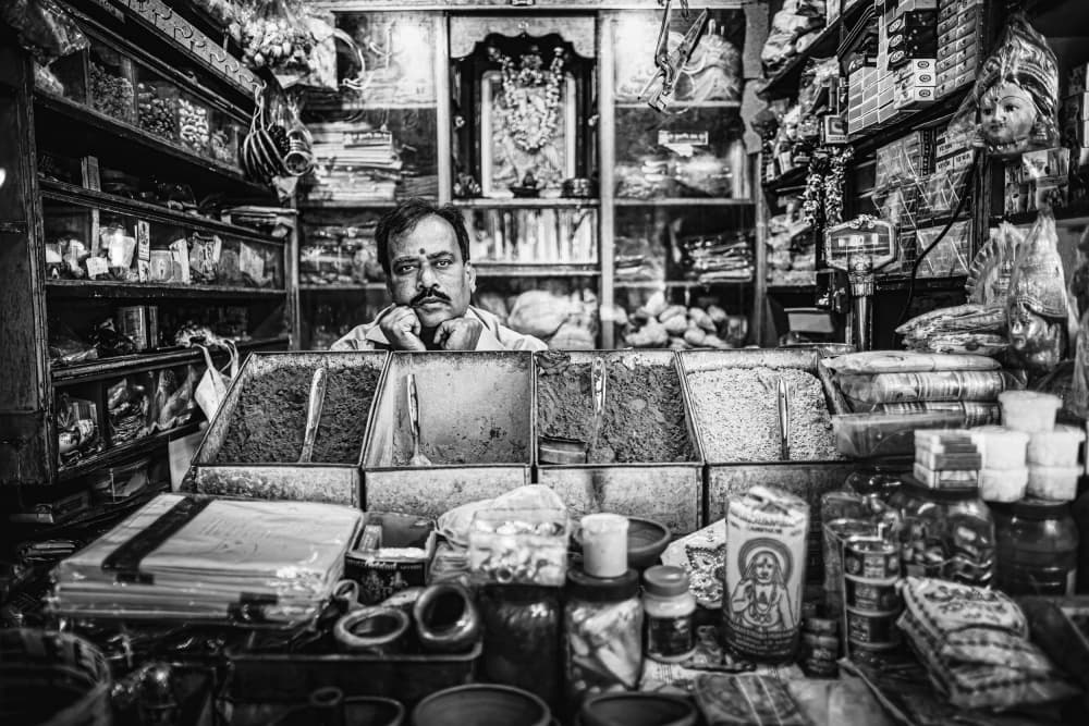 Pensive Indian Shopkeeper by Marco Tagliarino — canvas wall art