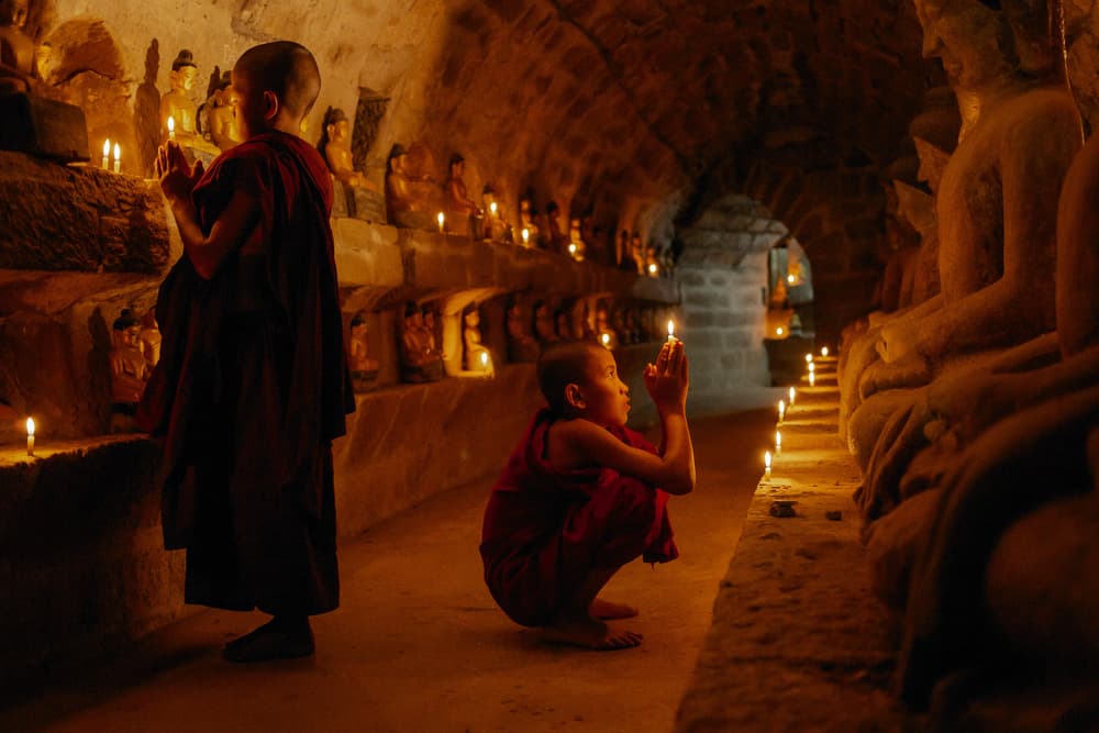 Monks in Candlelight Prayer by ADIREK M — canvas wall art