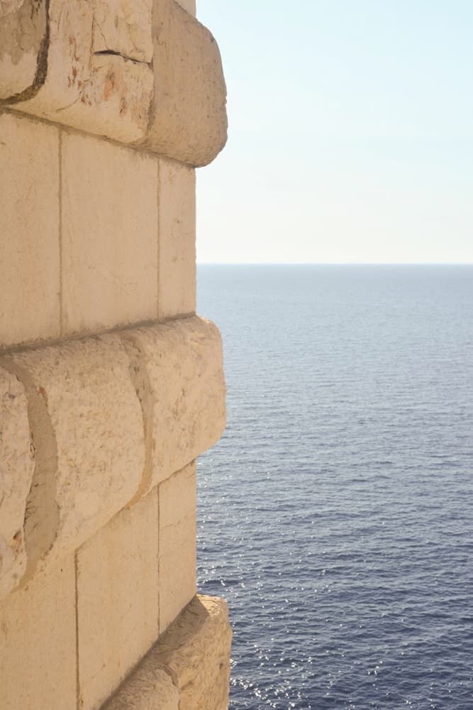 Stone Wall Ocean View by Talitha McQueen — canvas wall art