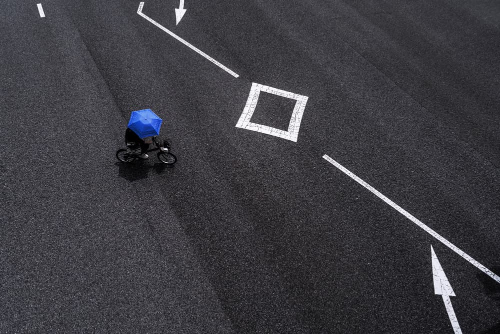 Blue Umbrella Cyclist by Tetsuya Hashimoto — canvas wall art
