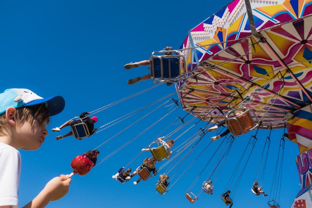 Boy With Carnival Swings by Gloria Salgado Gispert — canvas wall art