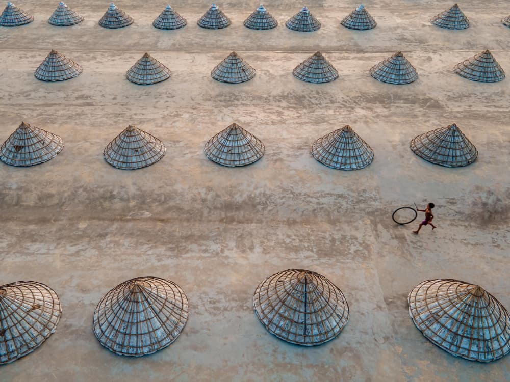 Child Running Among Cones by Rakibul Alam Khan — canvas wall art