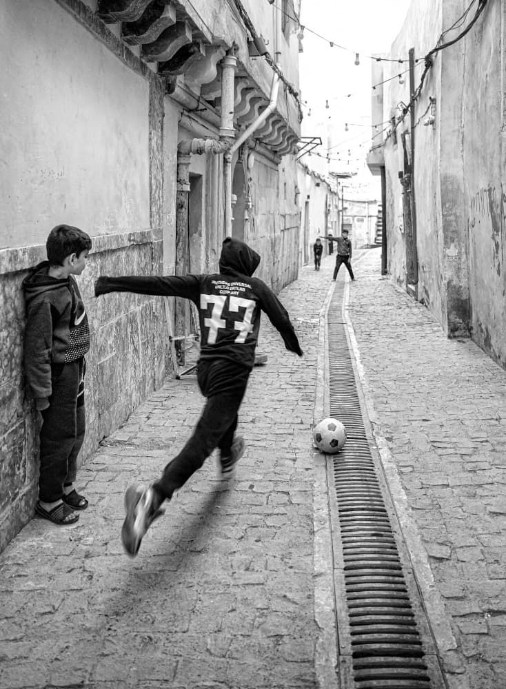 Boys' Street Soccer by Bashar Alsofey — canvas wall art