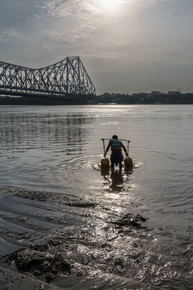 Howrah Bridge Water Carrier by Corinne Spector — canvas wall art