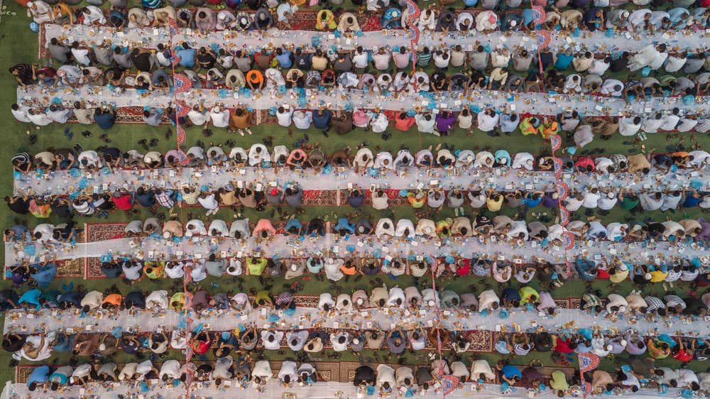 Communal Outdoor Feast by Mohammed Bustani — canvas wall art