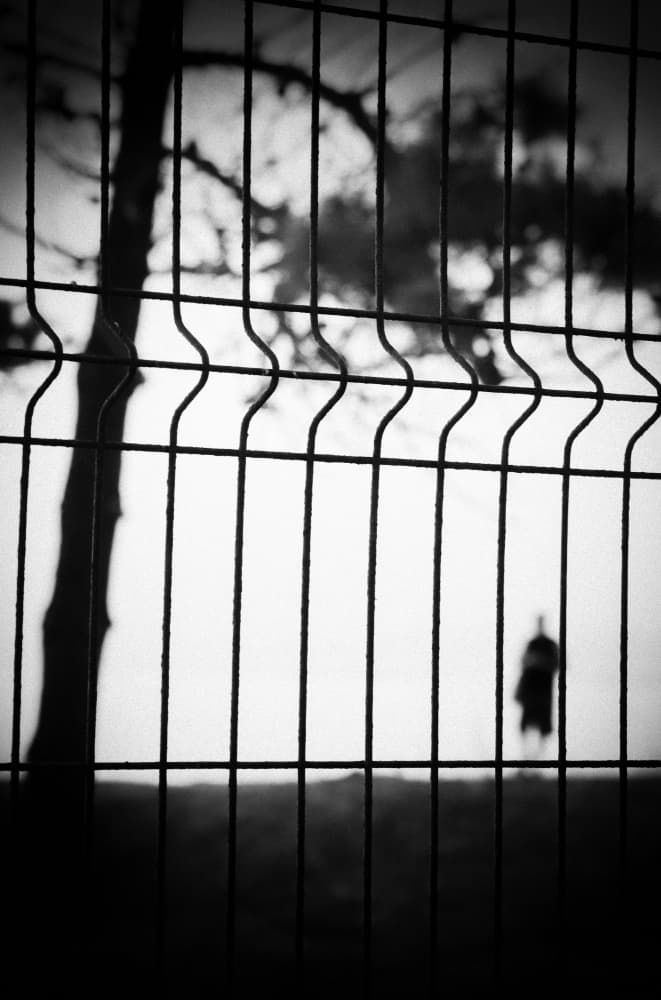 Fence and Solitary Figure by Milena Seita — canvas wall art