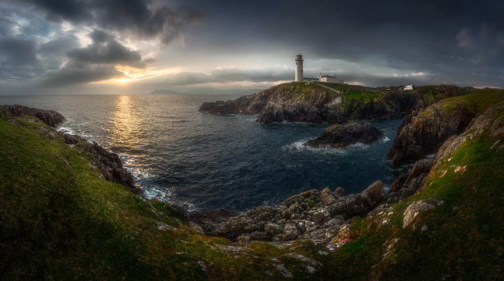 Dramatic Coastal Lighthouse Sunset by Tomasz Rojek — canvas wall art