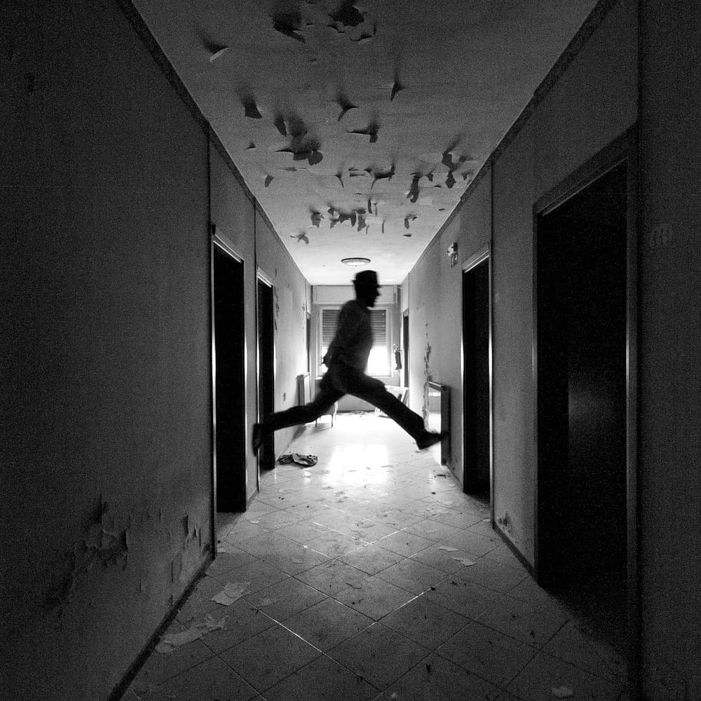Jumping Man Dark Hallway by Carlo Ferrara — canvas wall art