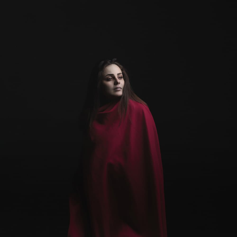 Pensive Woman in Red by Moein Hasheminasab — canvas wall art