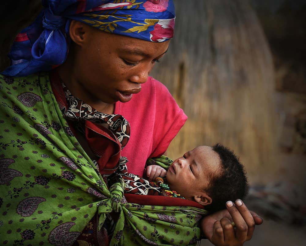 African Mother's Tender Embrace by Irene Perovich — canvas wall art