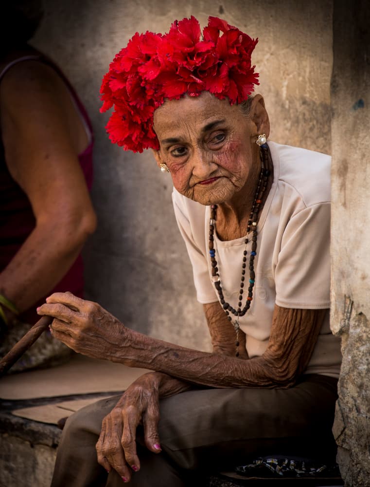 Cuban Woman Red Flowers by Peter Müller Photography — canvas wall art