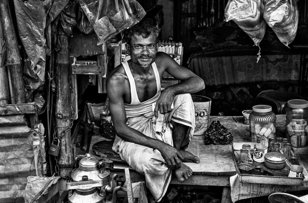 Smiling Indian Shopkeeper by Joxe Inazio Kuesta Garmendia — canvas wall art
