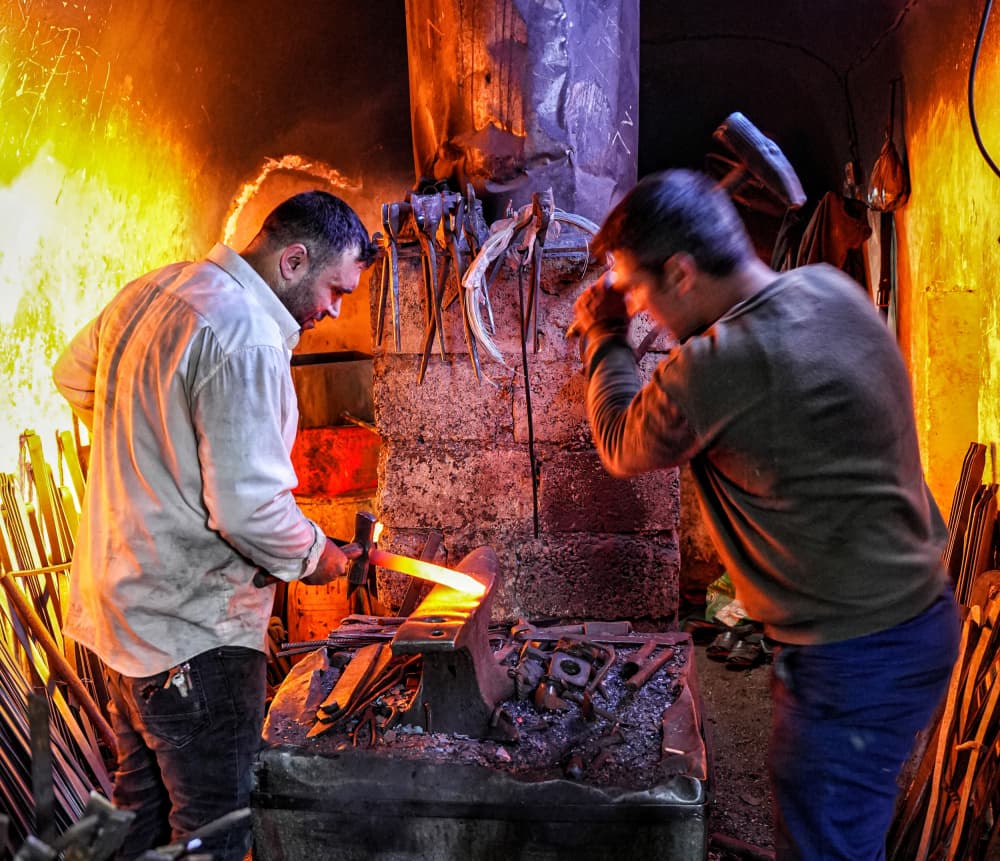 Blacksmiths at the Forge by Bashar Alsofey — canvas wall art