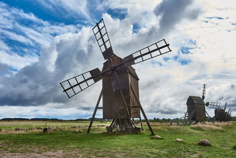 Rustic Windmills Under Clouds by Geertjan Plooijer — canvas wall art
