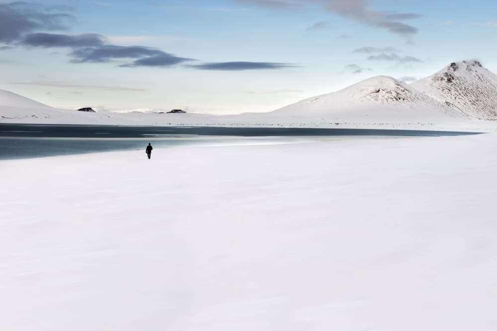 Lone Figure Winter Lake by Liloni Luca — canvas wall art