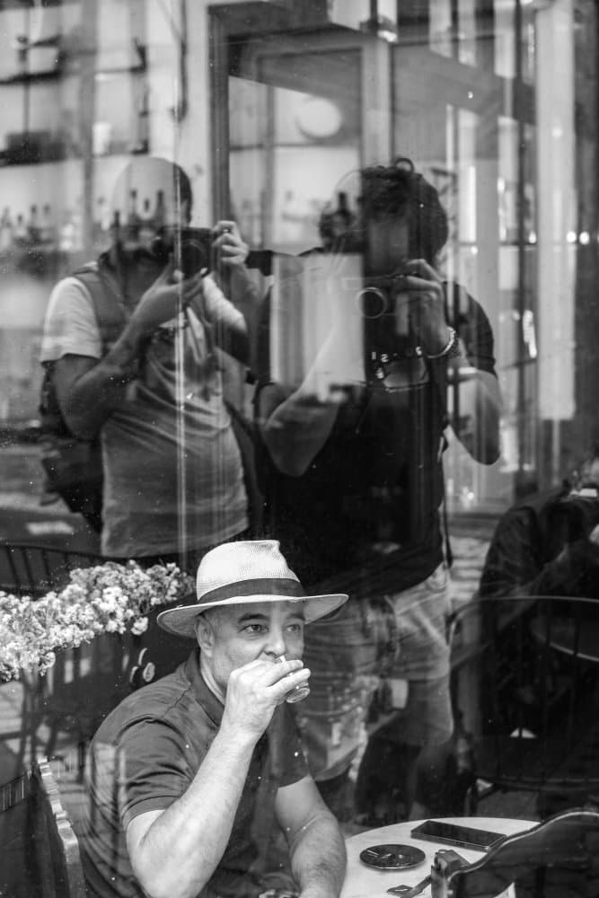 Fedora Man Cafe Reflections by Nicolau Wallenstein — canvas wall art
