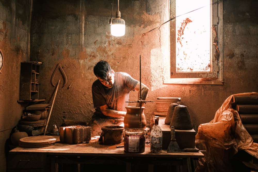 Potter Shaping Clay by Ali Ayer — canvas wall art