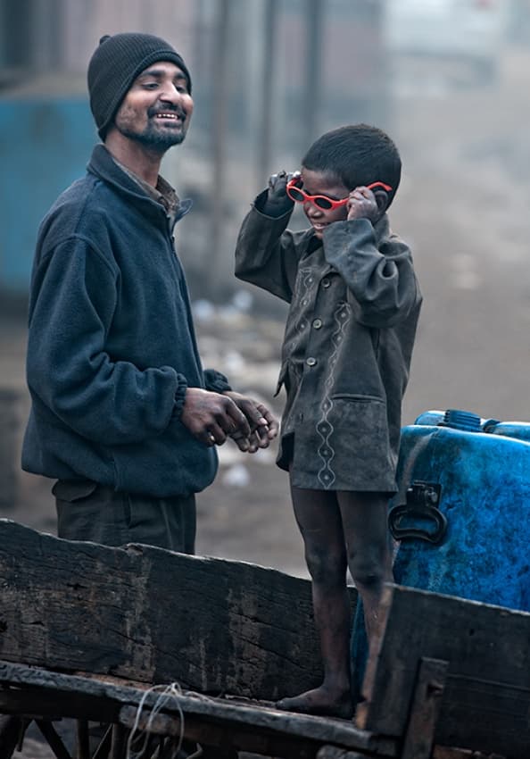 Boy Tries Red Sunglasses by Prateek Dubey — canvas wall art