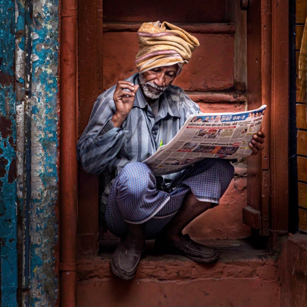 Indian Man Reading News by Susan Moss — canvas wall art
