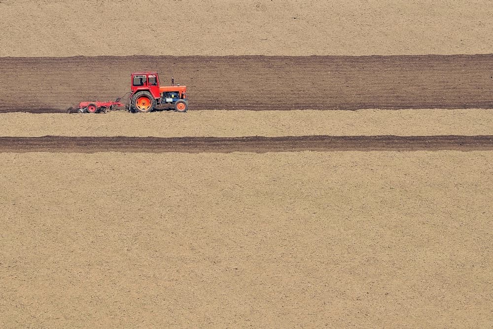 Red Tractor Plowing Field by Emilian Avramescu — canvas wall art