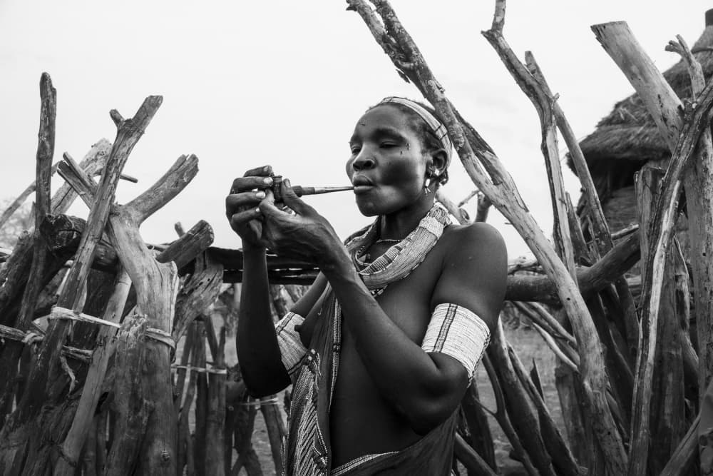 African Woman Lighting Pipe by Elena Molina — canvas wall art