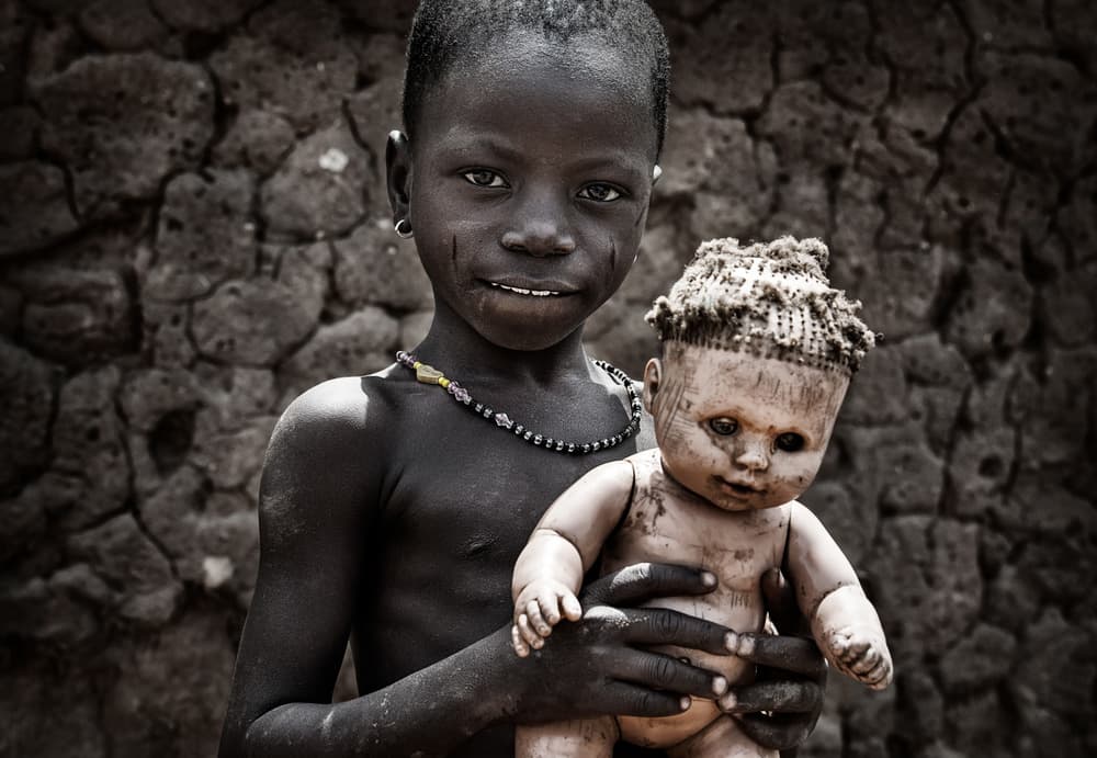 African Child with Doll by Joxe Inazio Kuesta Garmendia — canvas wall art