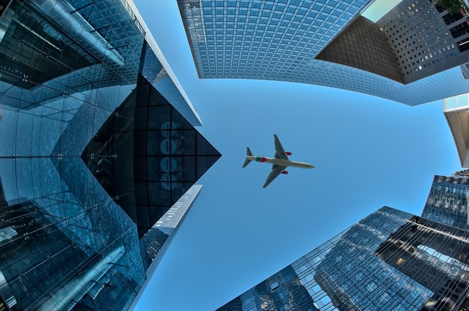 Airplane Over City Skyscrapers by Marc Pelissier — canvas wall art