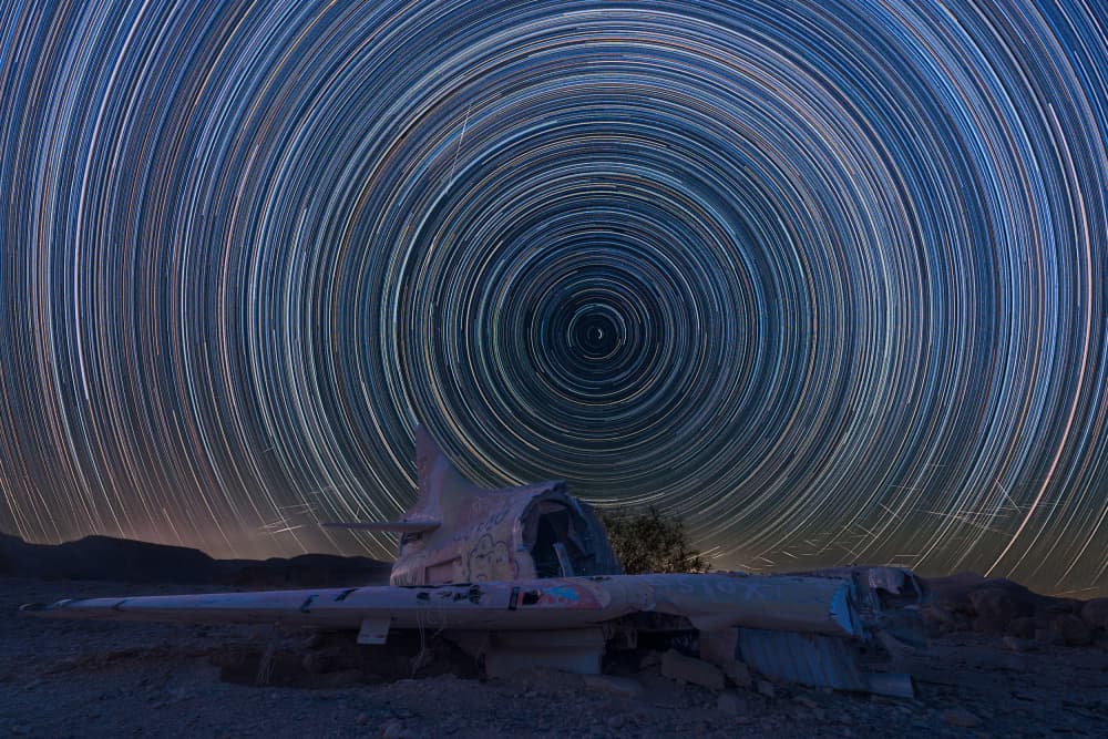 Star Trails Over Plane Wreck by Arie Burla — canvas wall art