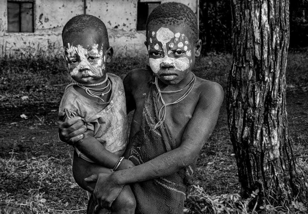 African Children Painted Faces by Joxe Inazio Kuesta Garmendia — canvas wall art