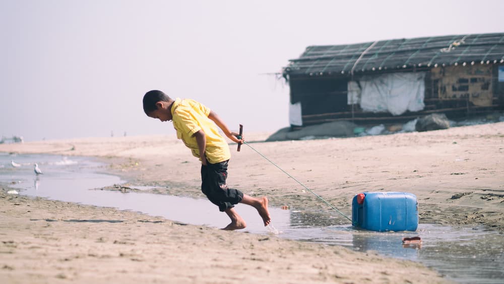Boy Pulling Water by Marcel Rebro — canvas wall art