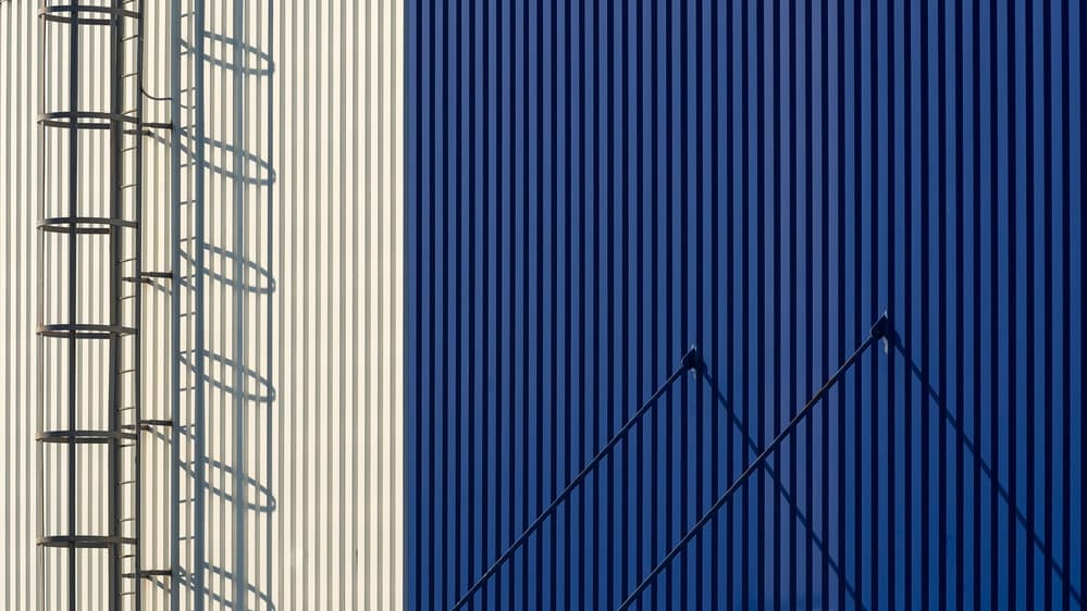 Blue Wall Ladder Shadows by Karol Važan — canvas wall art