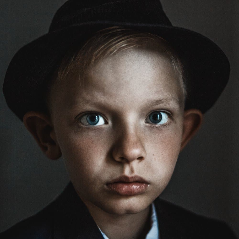 Boy In Dark Hat by Olessya Mikhailova — canvas wall art