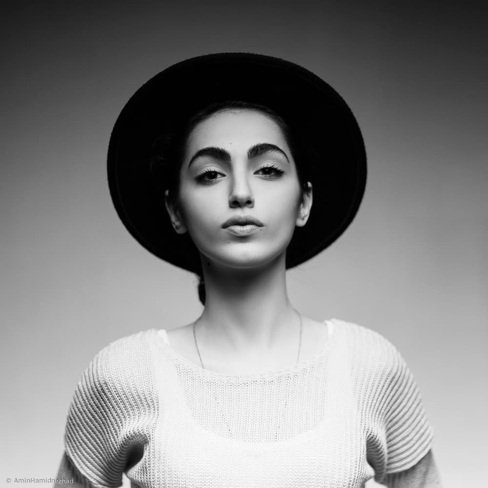 Confident Woman Black Hat by Amin Hamidnezhad — canvas wall art