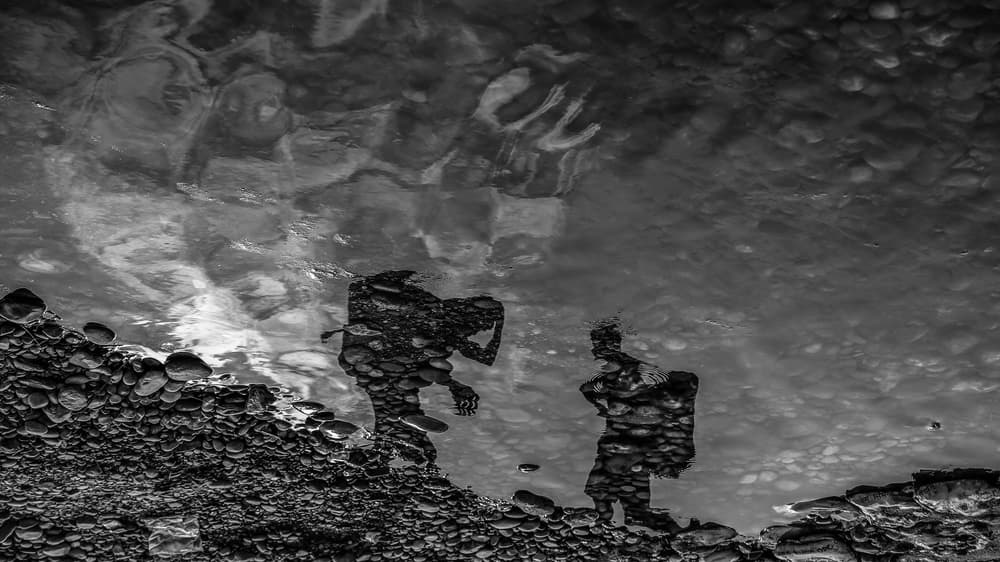 Monochrome River Reflections by Ummu Nisan Kandilcioglu — canvas wall art