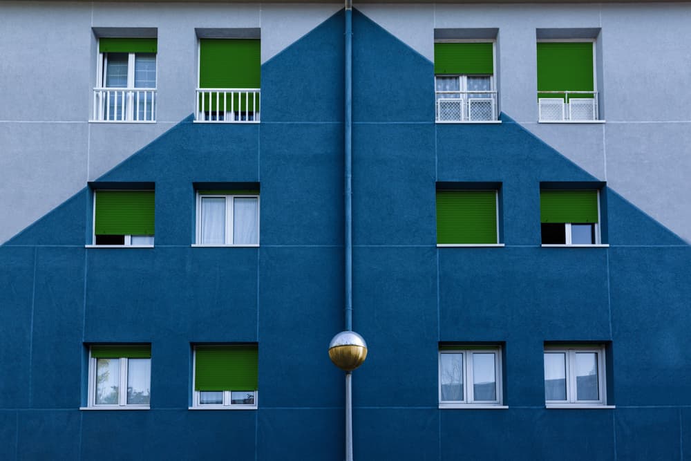 Blue Building Green Blinds by Jois Domont ( J.L.G.) — canvas wall art