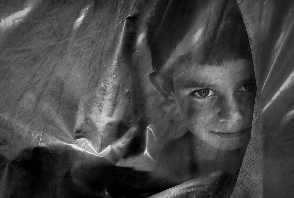 Curious Boy Behind Plastic by Emine Basa — canvas wall art