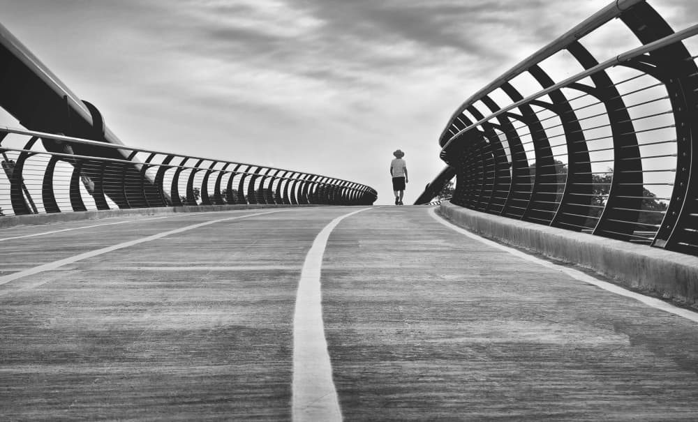 Lone Figure on Modern Bridge by Emma Zhao — canvas wall art