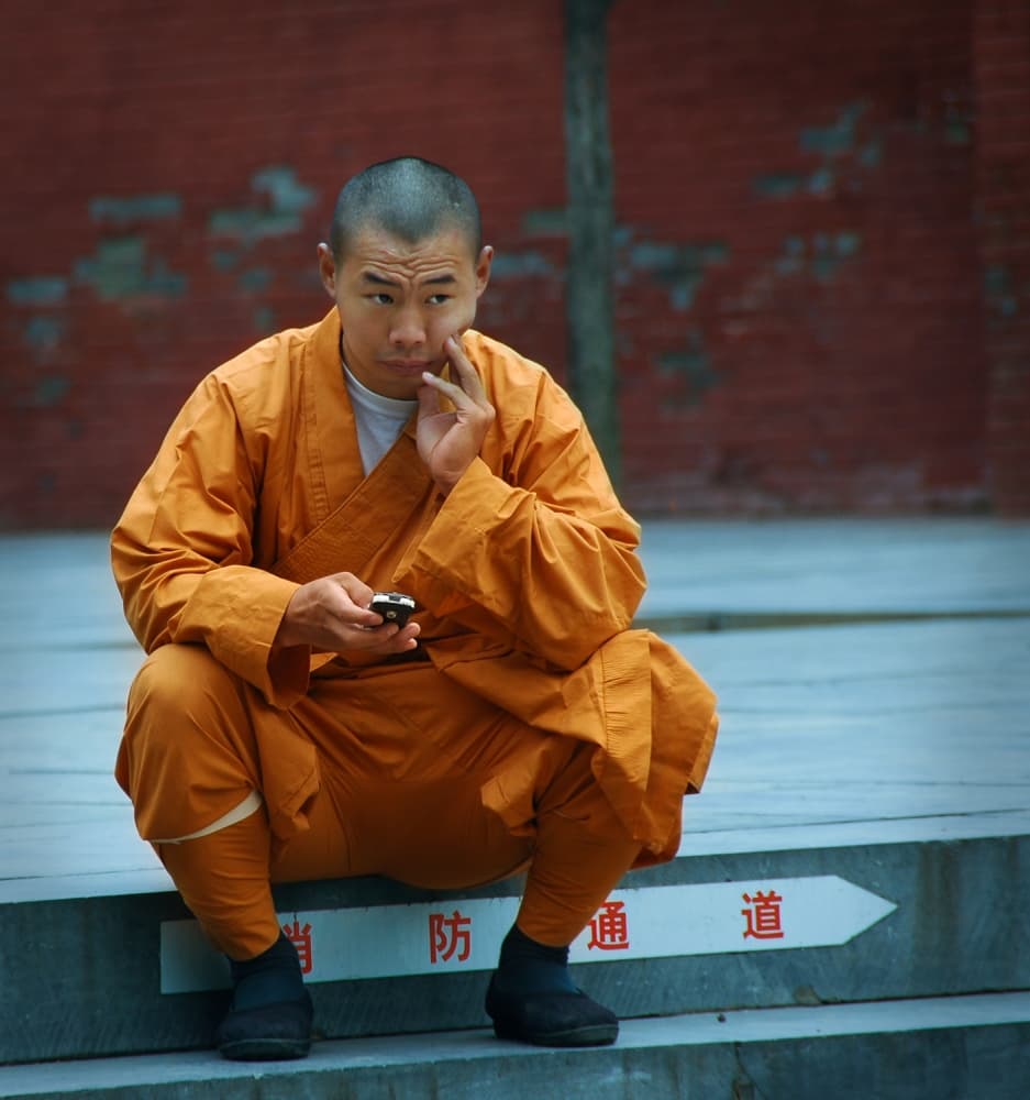 Pensive Monk with Phone by Jacek Stefan — canvas wall art