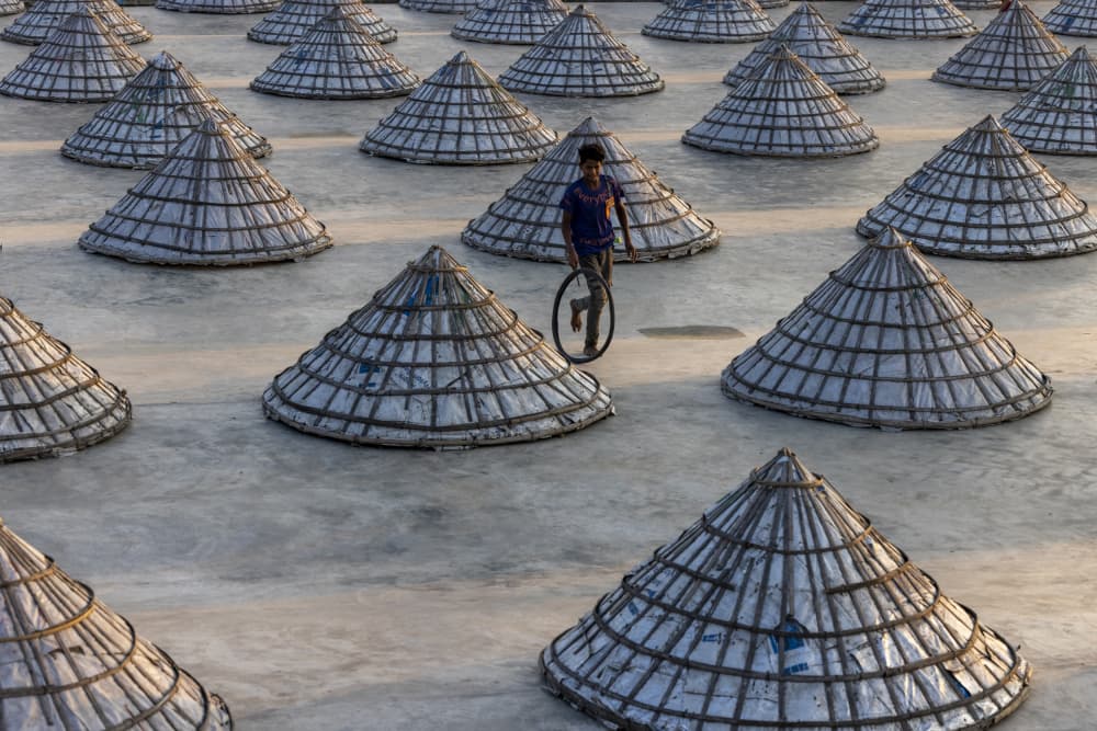 Boy Among Salt Cones by Azim Khan Ronnie — canvas wall art