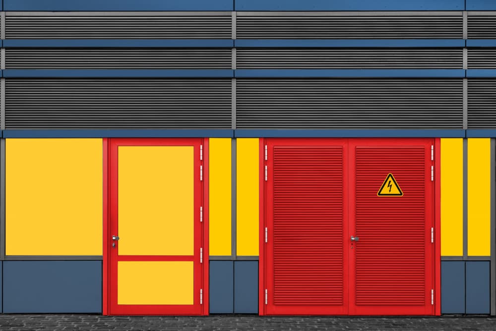 Red Doors Yellow Building by Roland M Schwerdtfeger — canvas wall art
