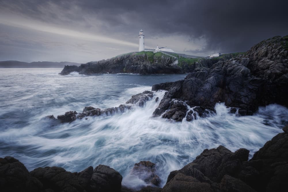 Lighthouse Amidst Crashing Waves by Junbo Liang — canvas wall art